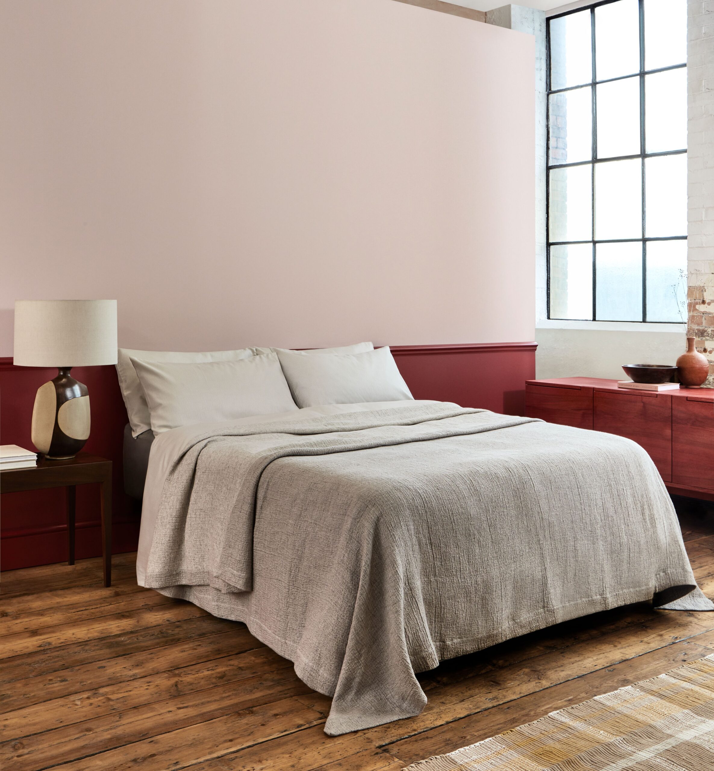 A bedroom with red accents by Mylands Paints