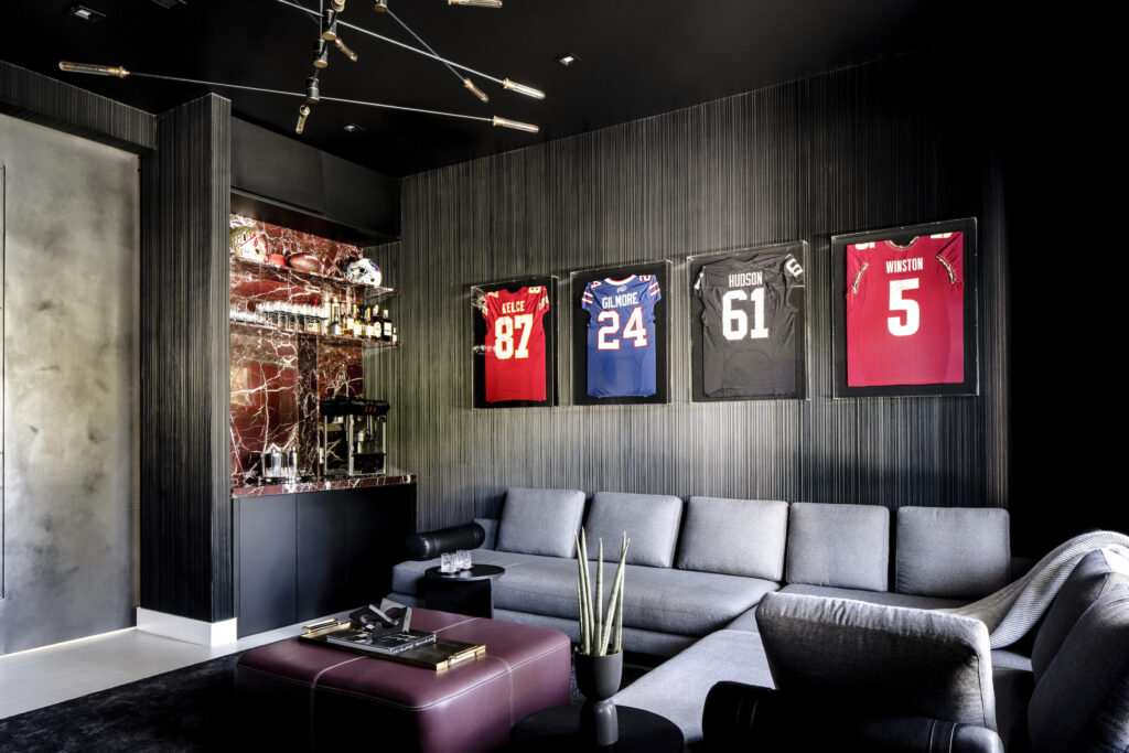 Sporting memorabilia in a living room interior designed by Eilyn Jimenez at the home of Erik Rodriguez “EJ” Manuel Jr in Effect Magazine