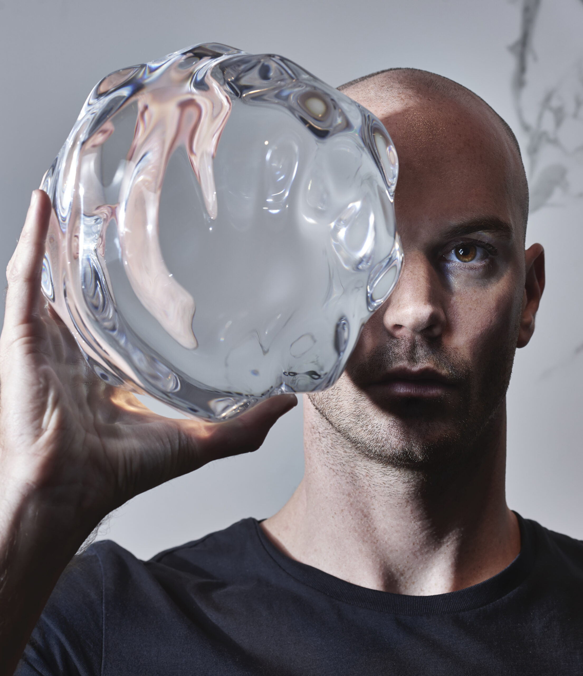 Benjamin Hubert with glass sphere from LAYER's Raytrace installation in Milan - Effect Magazine
