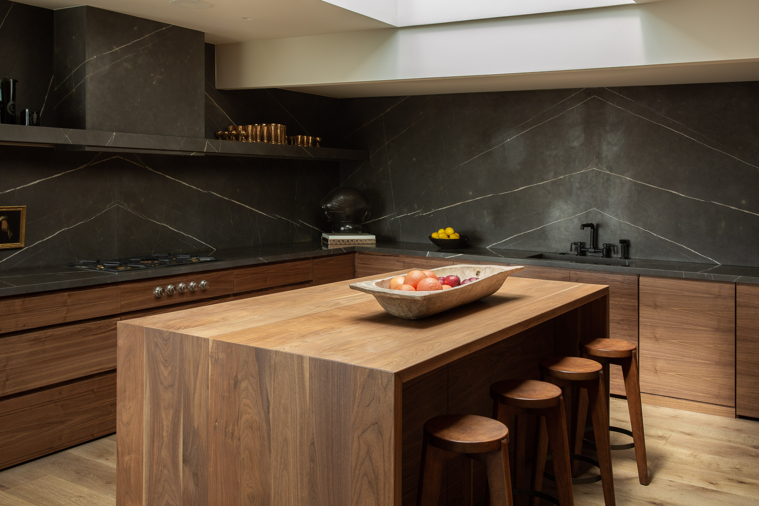 Kitchen design trends in 2023 are likely to include black marble, as with the Rising Glen project by OSKLO in Effect Magazine