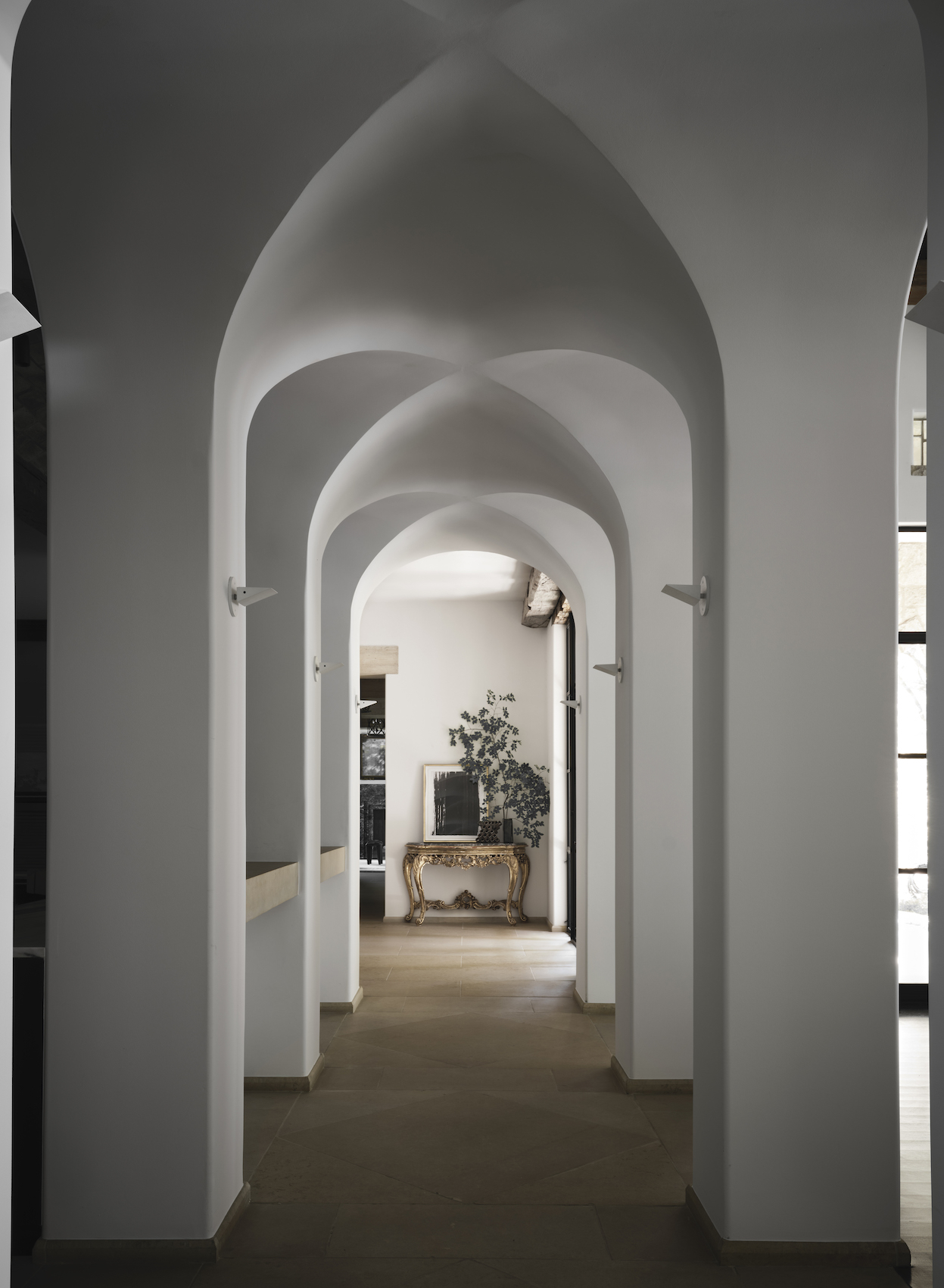 Arched corridor of a house interior designed by Chad Dorsey in Effect Magazine