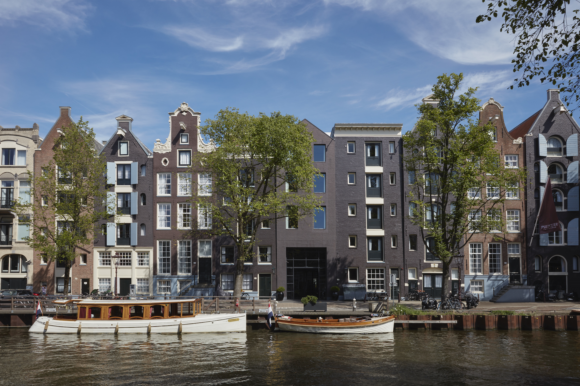 External view of the one-of-a-kind Pulitzer Hotel in Amsterdam, which was created out of 25 interconnected Golden Age canal houses. Designed by Jacu Strauss of the Lore Group - Effect Magazine