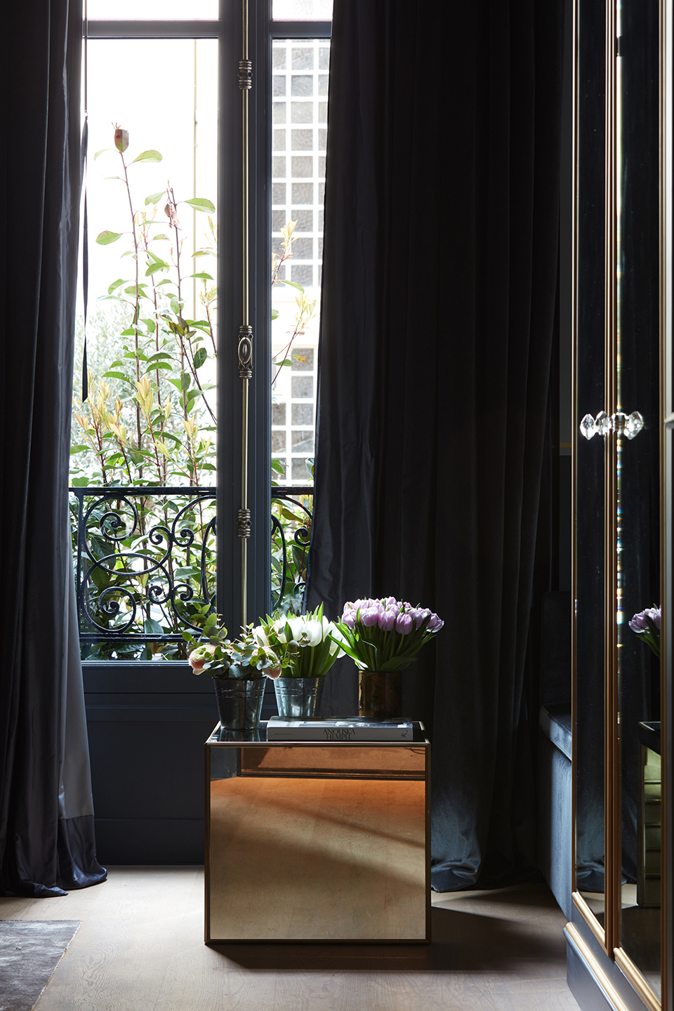 Drapery over crisp French doors, with brass window furniture and wrought-iron balconies from an integral part of Anouska Hempel's scheme for Monsieur George - Effect Magazine